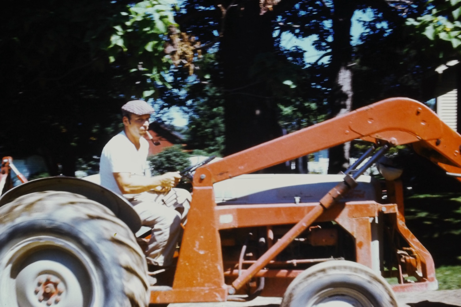 Grandfather on the tractor at the building site, 1963