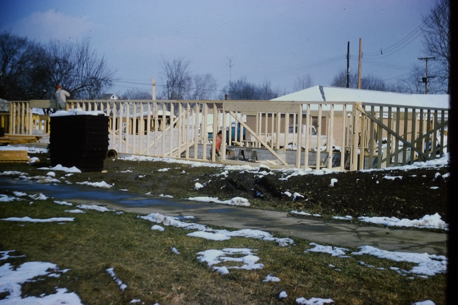 Framing goes up through the winter snow, December 1963